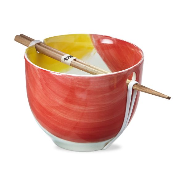 coral and yellow noodle bowl with chopsticks resting across it.