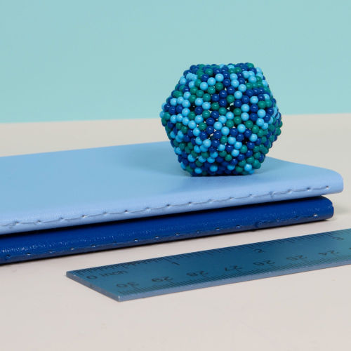 geometric shape made from Gigabyte speks set on a stack of books