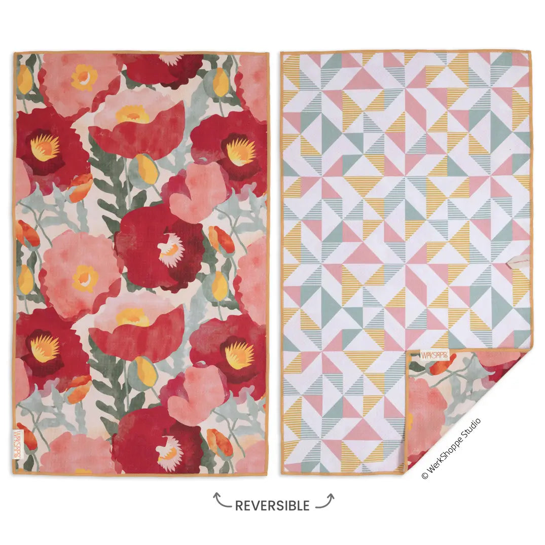 both sides of a reversible towel with red florals on one side and a geometric pattern on the other