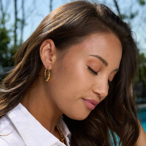 side view of a person wearing gold Waterproof Twisted Chunky Hoop Earrings