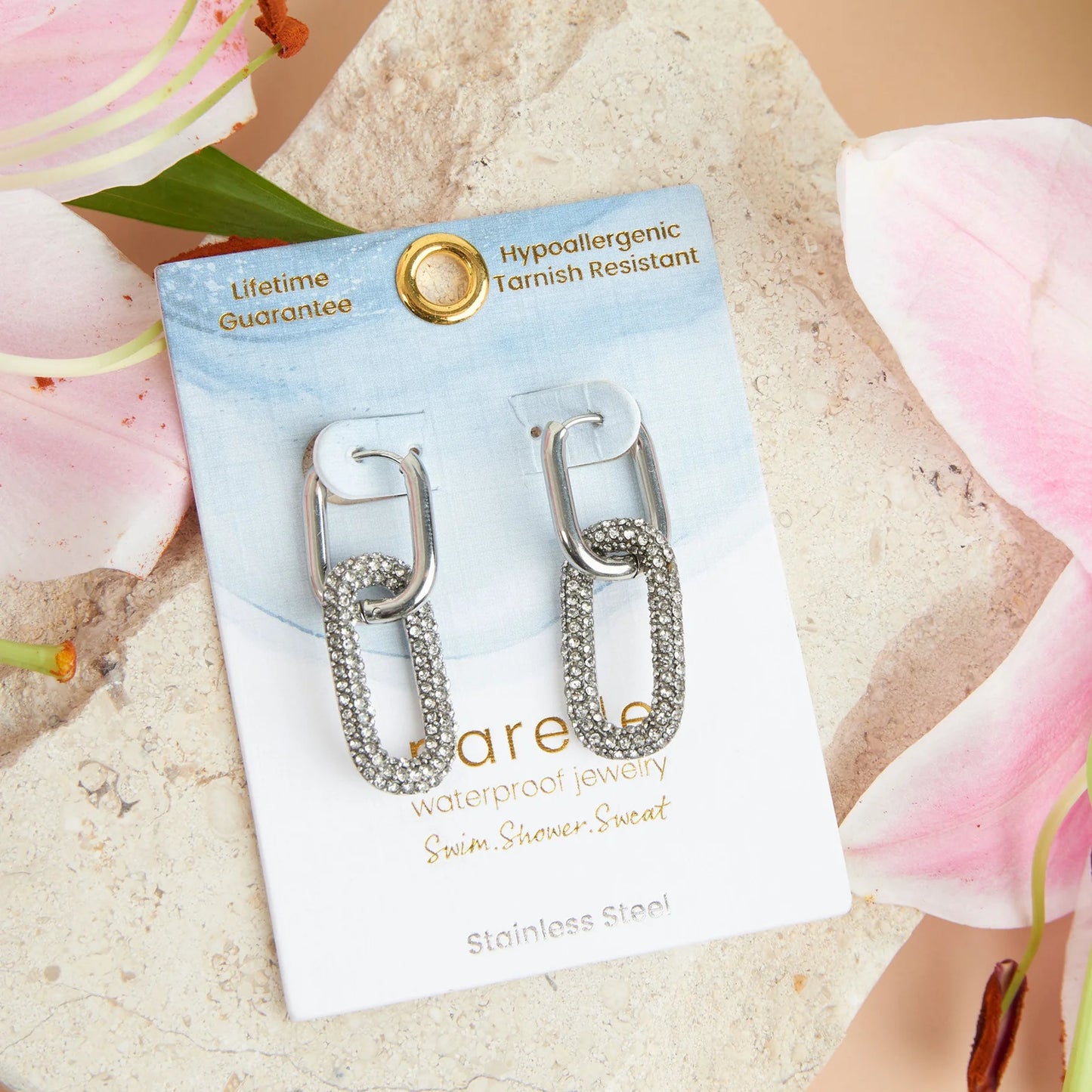 silver Narelle Waterproof Pave Linked Hoop Earrings on their card packaging