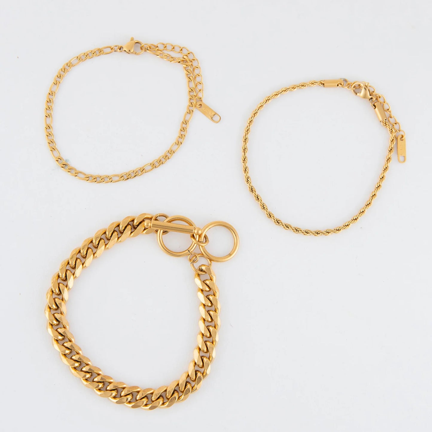 gold Waterproof Figaro Chain Bracelet Set laying flat on a white background