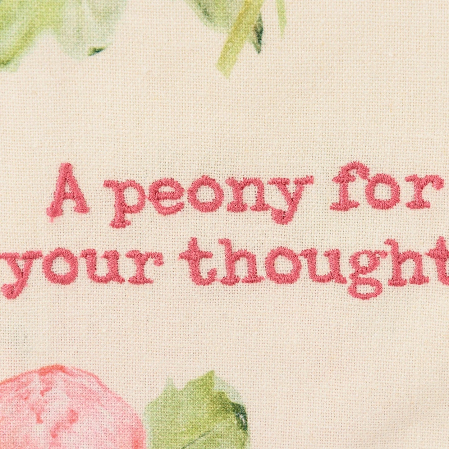 close-up of "a peony for your thoughts" embroidery on towel