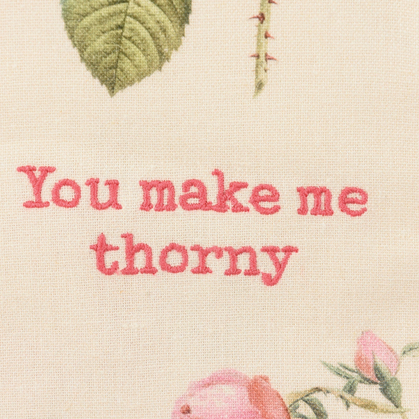 close-up of embroidery on You Make Me Thorny Dishtowel