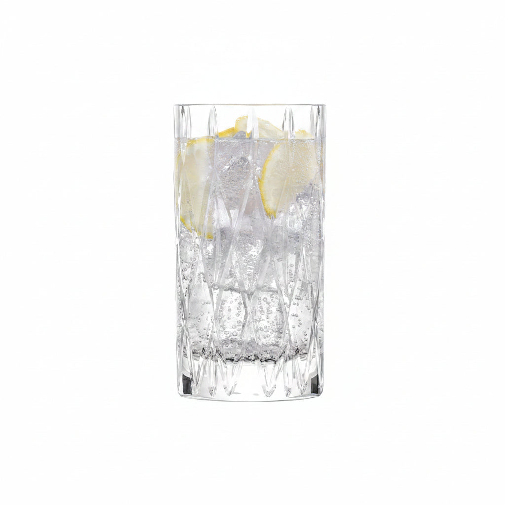 tumble drinking glass filled with beverage and lemon slices