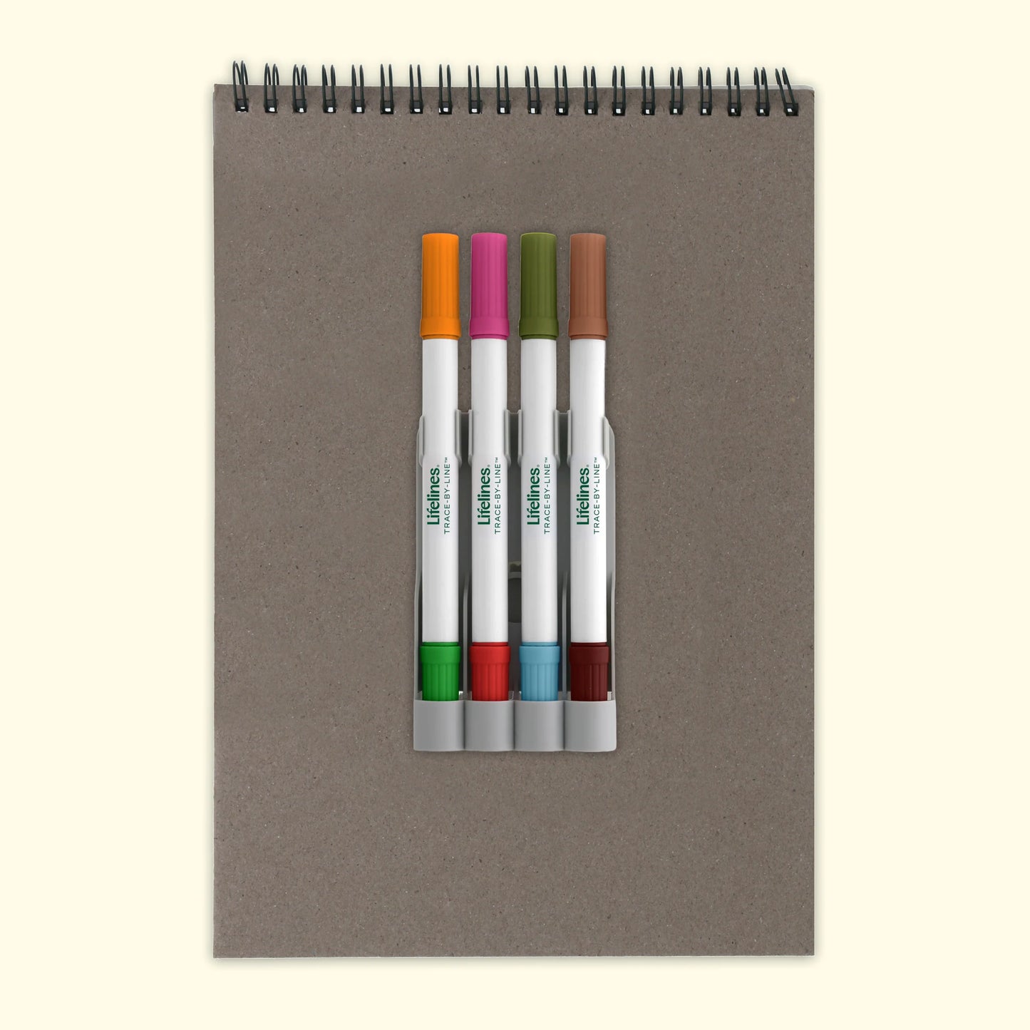Notebook with a set of white markers on a beige background