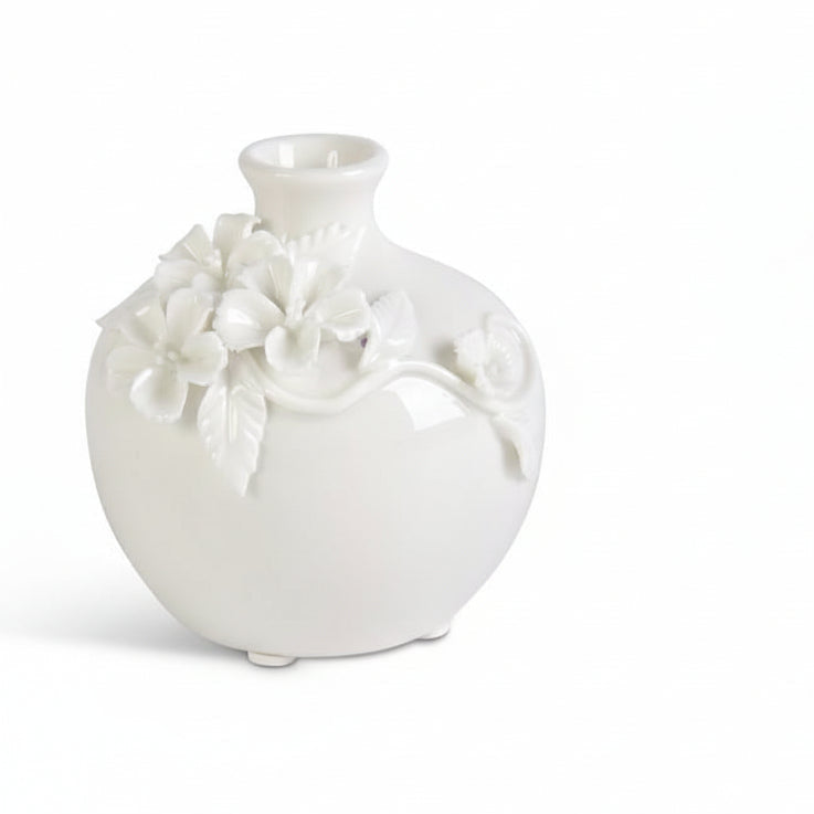 white ceramic vase with floral cluster designs on a white background