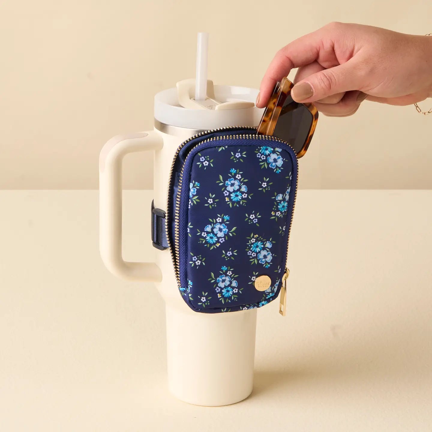 hand putting sunglasses into Endless Daydream Tumbler Fanny Pack