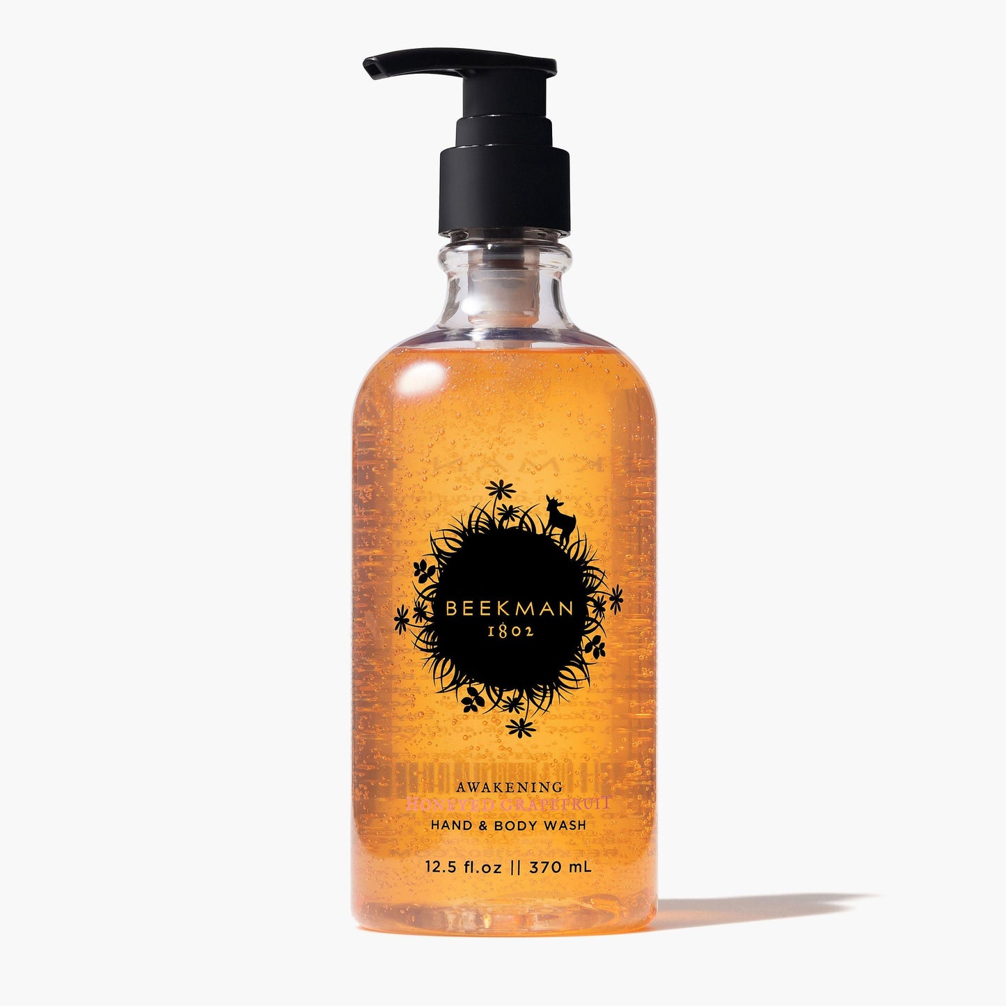 pump bottle of Honeyed Grapefruit Hand & Body Wash on a white background.