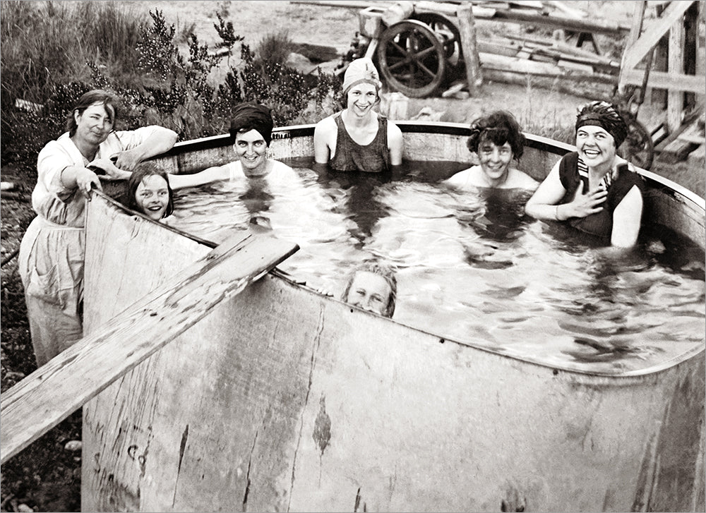 front of card is black and white, women inside a water tank