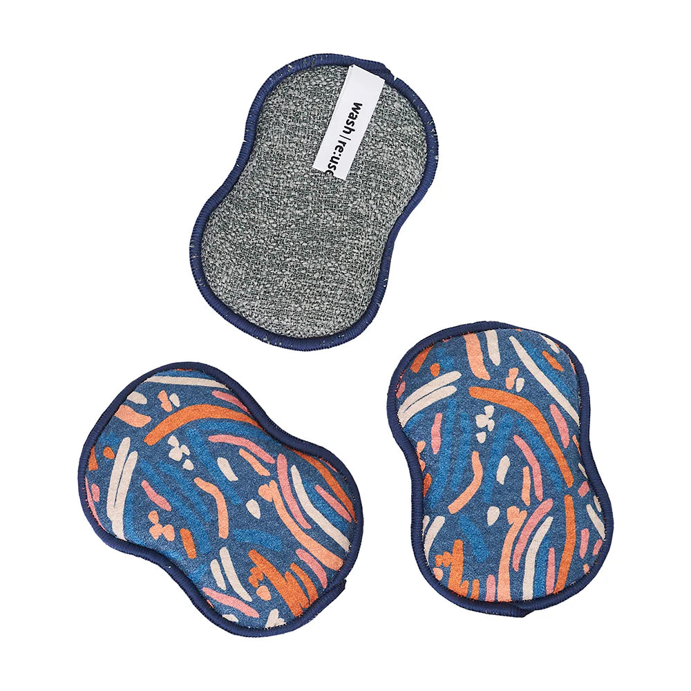 3 paintbrush sponges with one flipped over showing scrubbing side