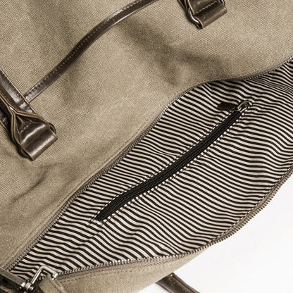 interior view of khaki duffle bag showing striped lining.