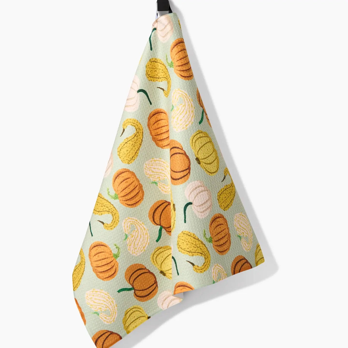 Pumpkins And Gourds Tea Towel draped on a hook