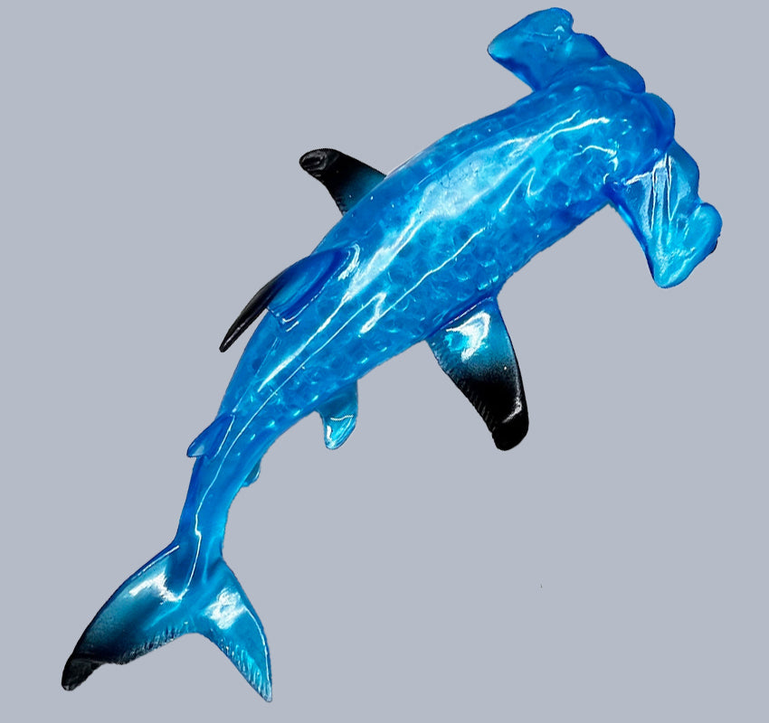 blue hammerhead shark squish toy on grey background