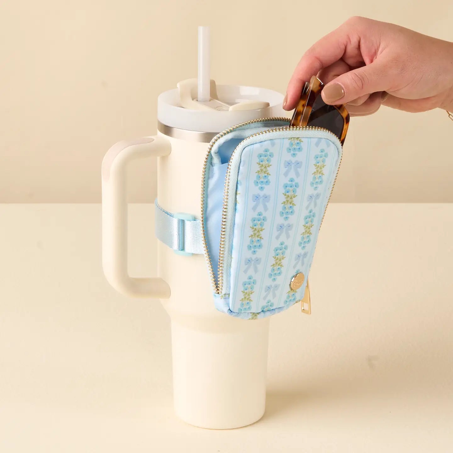 hand putting sunglasses into Blue Oh-So-Fancy Tumbler Fanny Pack