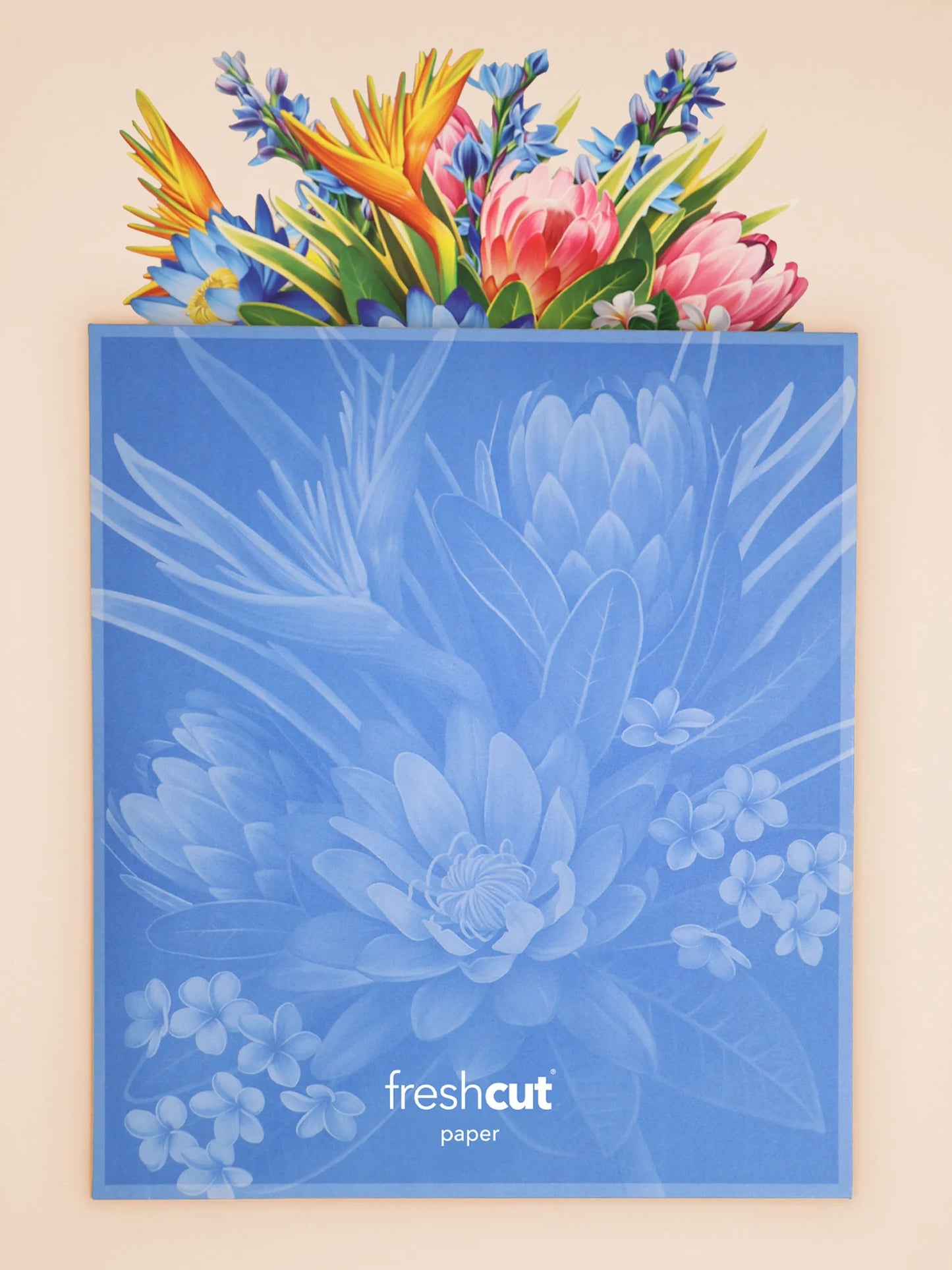 Tropical Paradise Pop-Up Bouquet coming out of its blue envelope