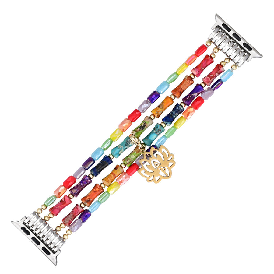 Stretch Lotus Chakra apple watch strap made of muti colored beads and lotus charm laying flat on a white background.
