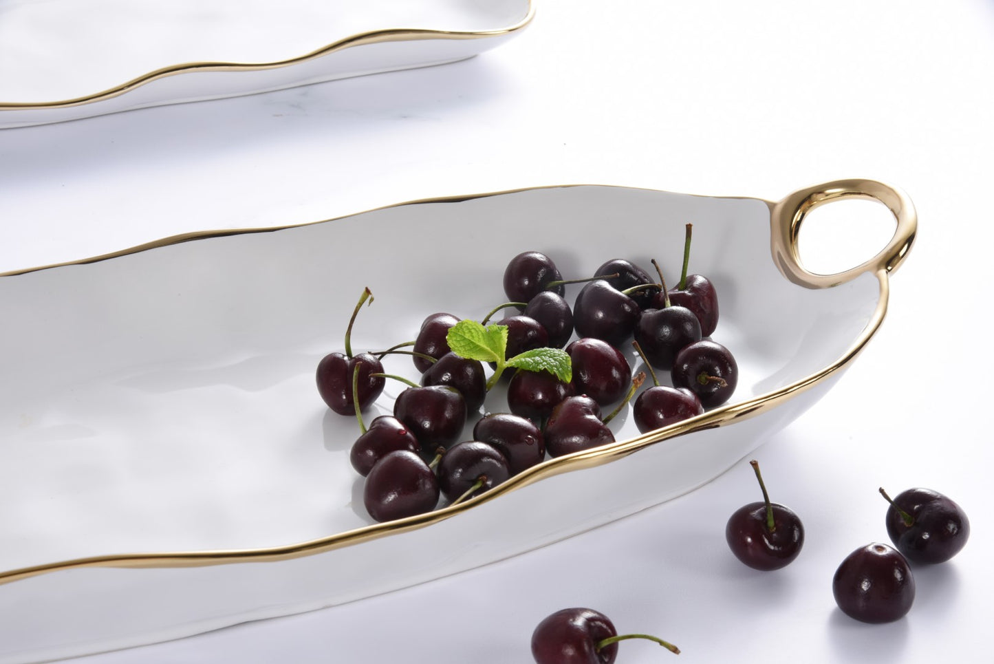 close-up of Golden Handles Long Server with cherries in it.
