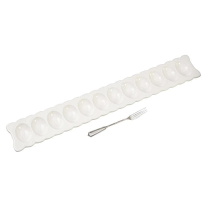 scalloped egg tray and serving fork on a white background.