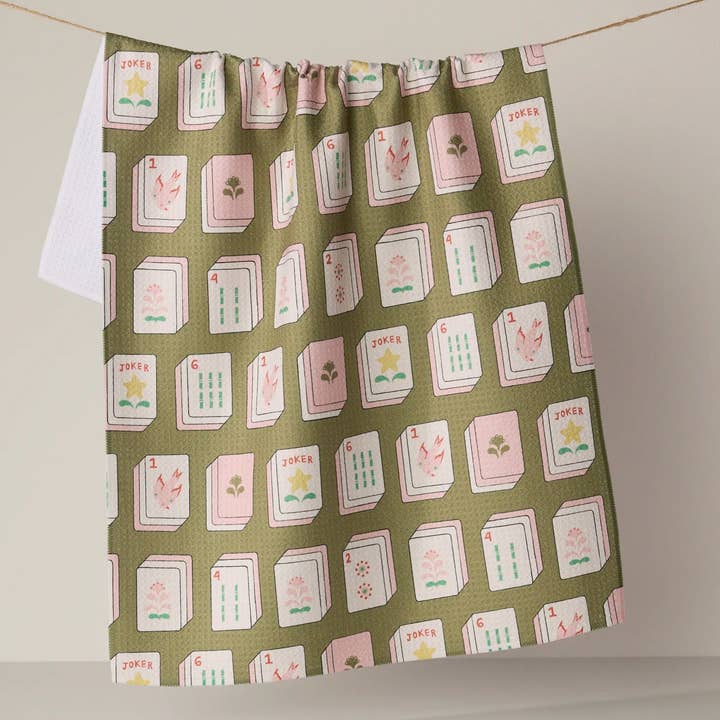 flower tiles mahjong tea towel hanging on a clothesline on a grey background