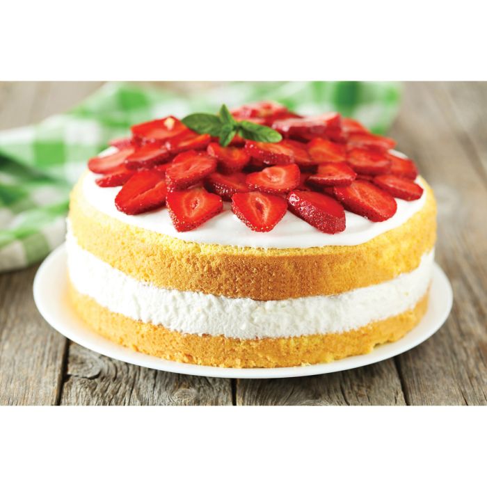 layered cake with icing and strawberries arranged on top