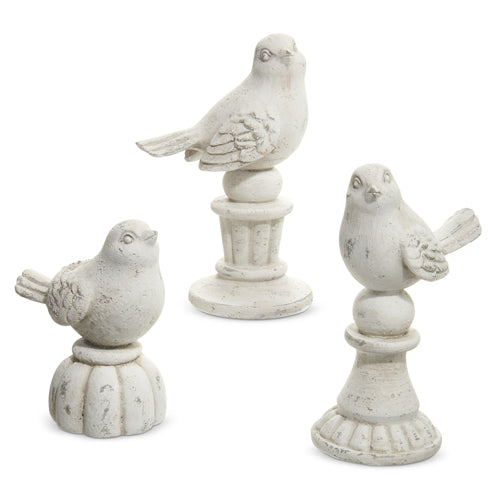 3 sizes of resin birds on pedestals.