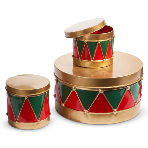 three drum canisters in varying sizes with a geometric pattern in red, green, and gold arranged on a white background