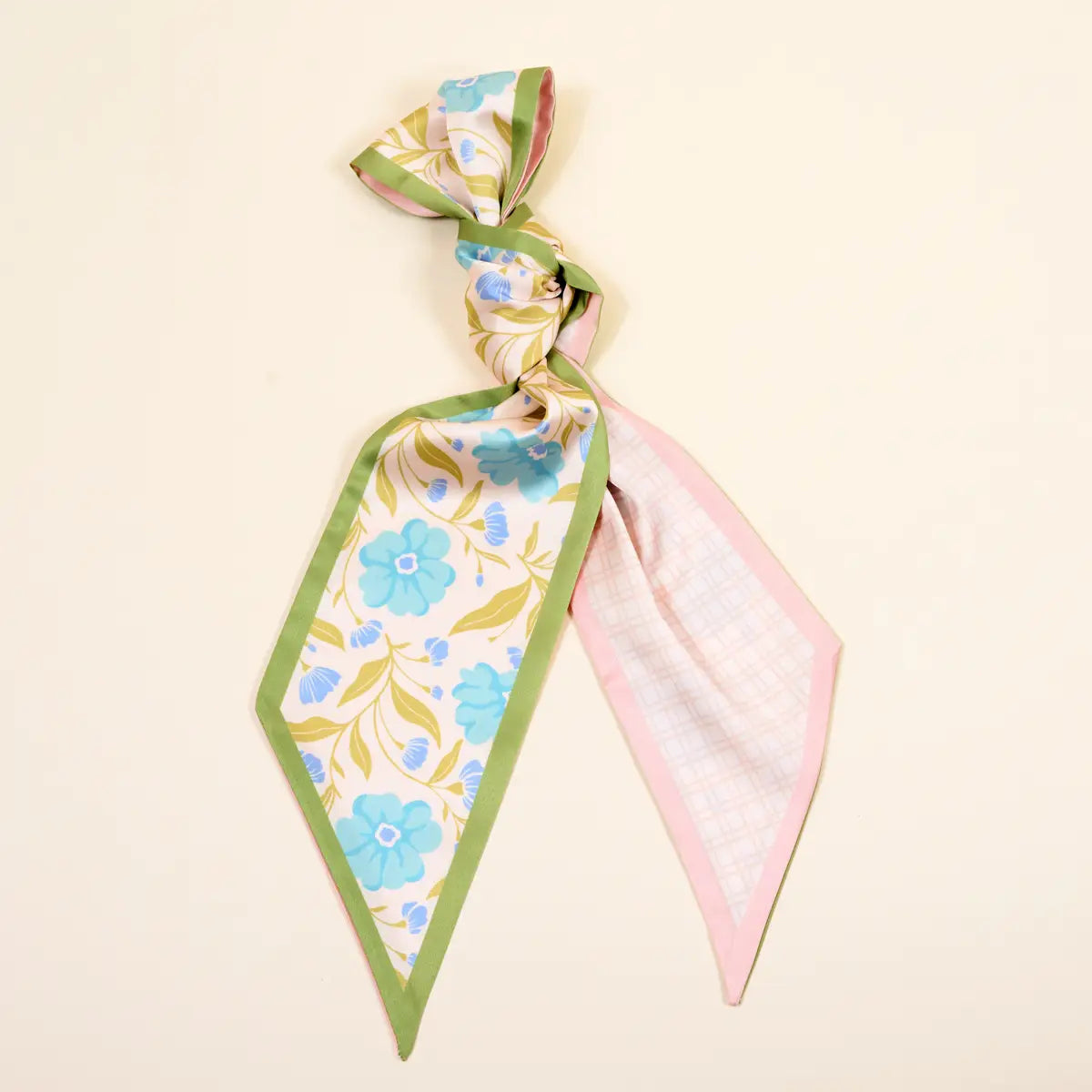 Floral patterned scarf with green border on a beige background