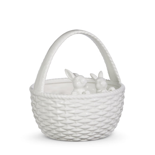 white ceramic basket with bunnies looking over the rim from the inside