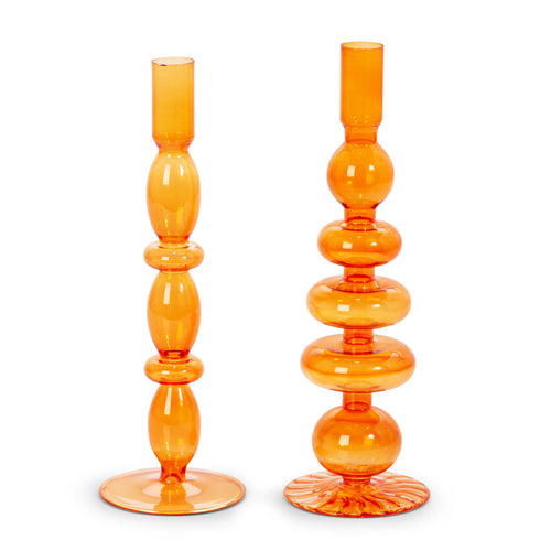 2 styles of orange glass candle sticks