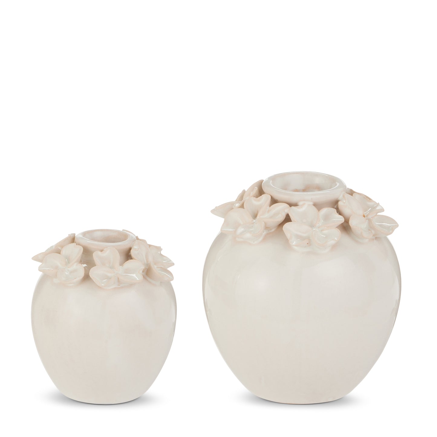 2 white vases with flowers on the rim