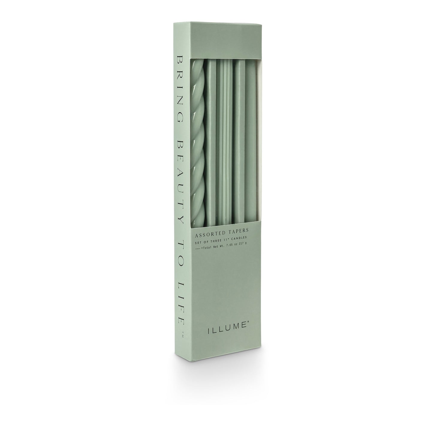 three assorted green taper candles in their packaging