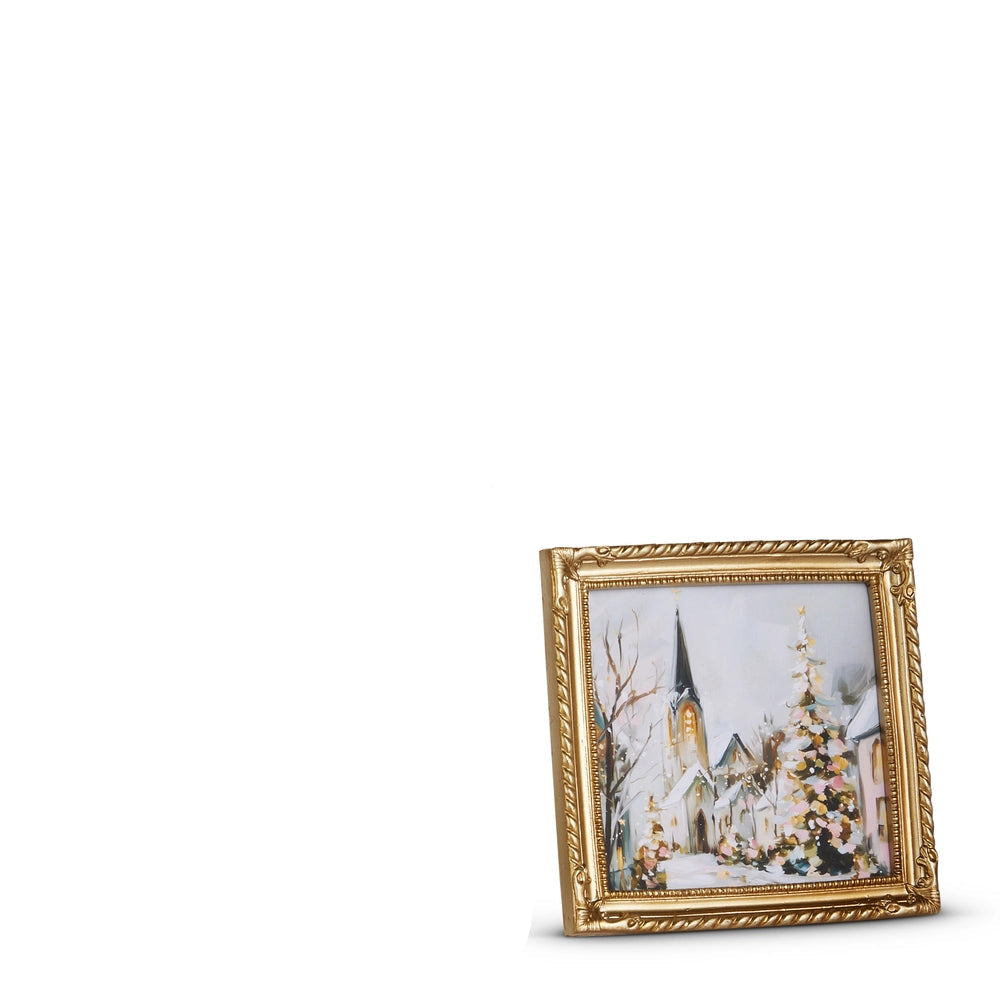 small gold frame art of church in snowy village at christmas time
