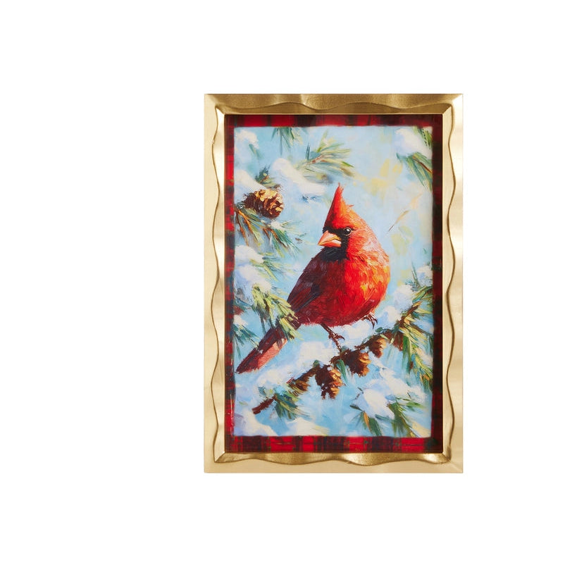 A framed holiday art print of a red cardinal perched on a snowy pine branch, with a gold scalloped frame on a white background.