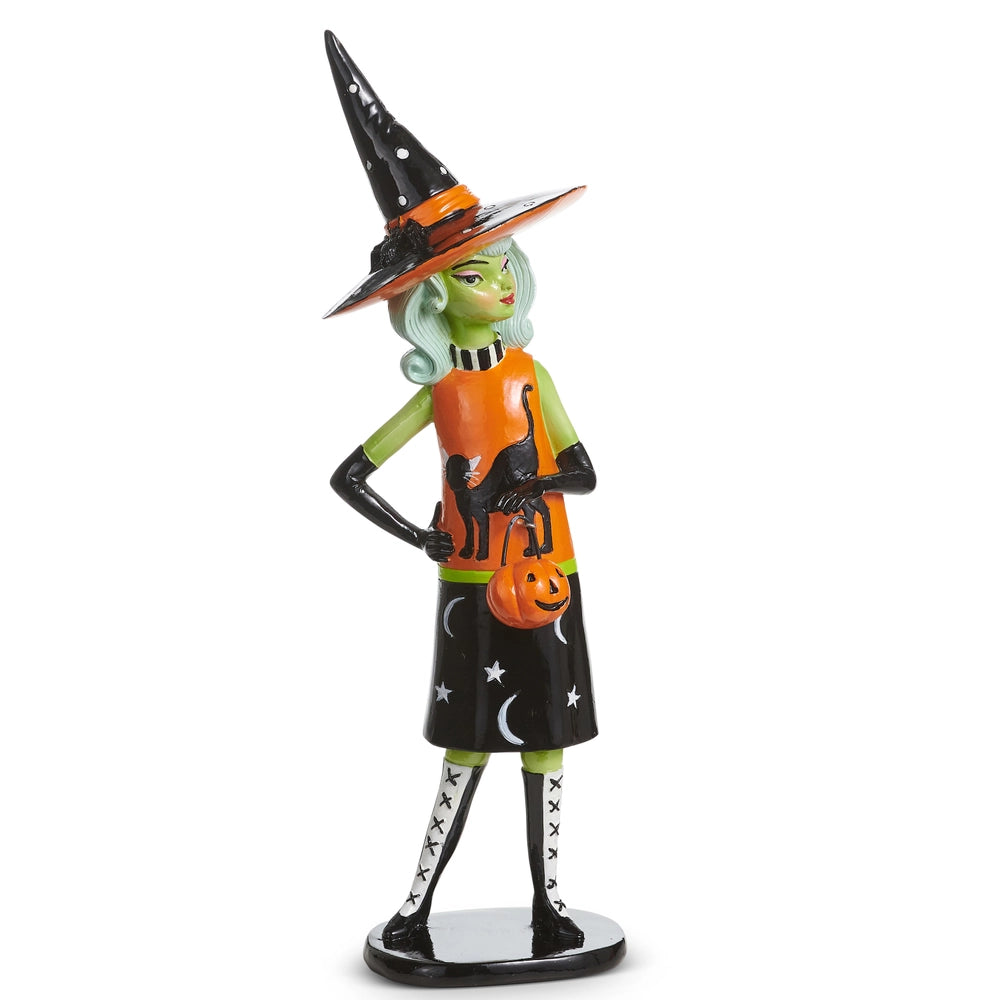 Figurine of a green witch wearing a cute black and orange dress with a black cat on it and a pointed witch's hat
