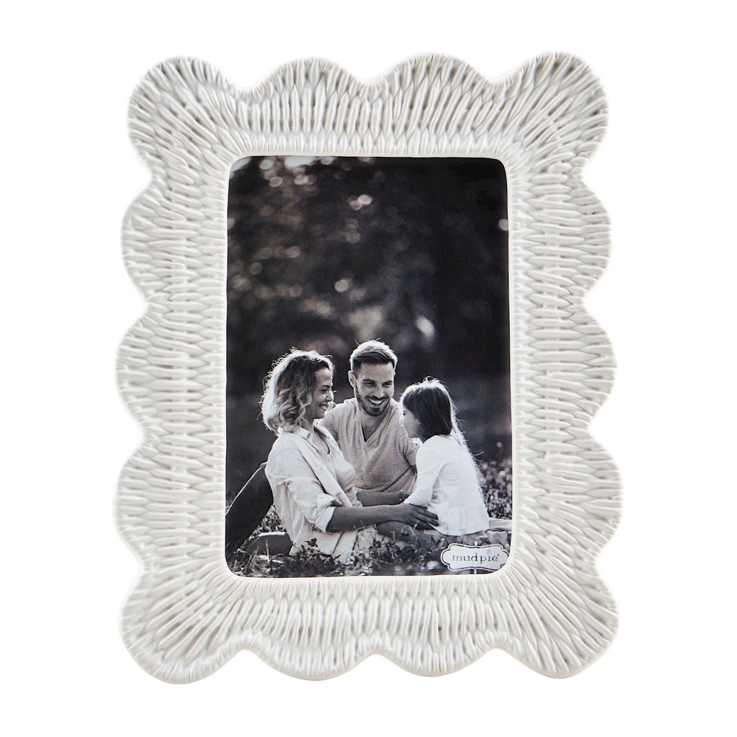 large ceramic photo frame with woven texture, scalloped edge, and black and white image of a family in it.