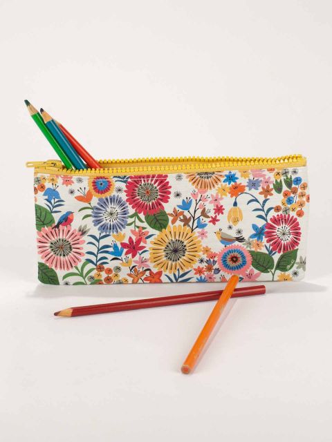 Flower Field Pencil Case with pencils sticking out and two laying next to it on a white background