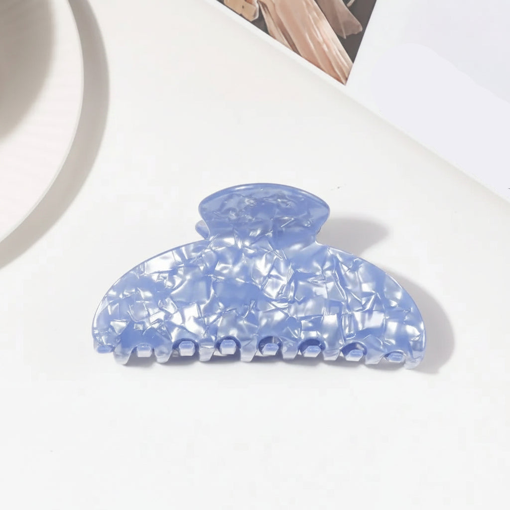 A light blue claw hair clip shown on a white background