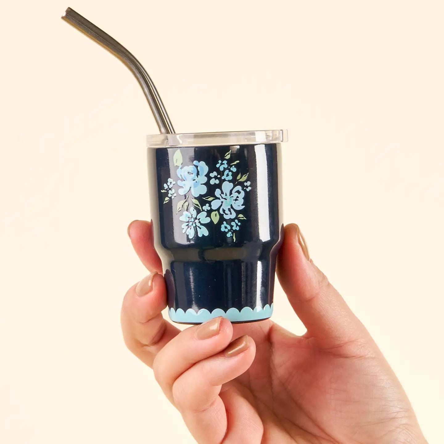 hand holding Navy Garden Blooms tiny tumbler