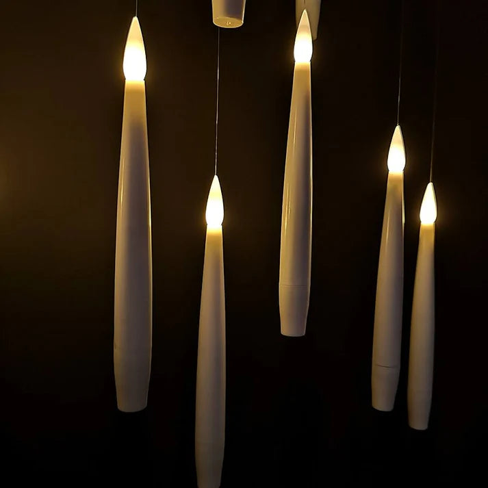 close-up of hanging candles on a dark background