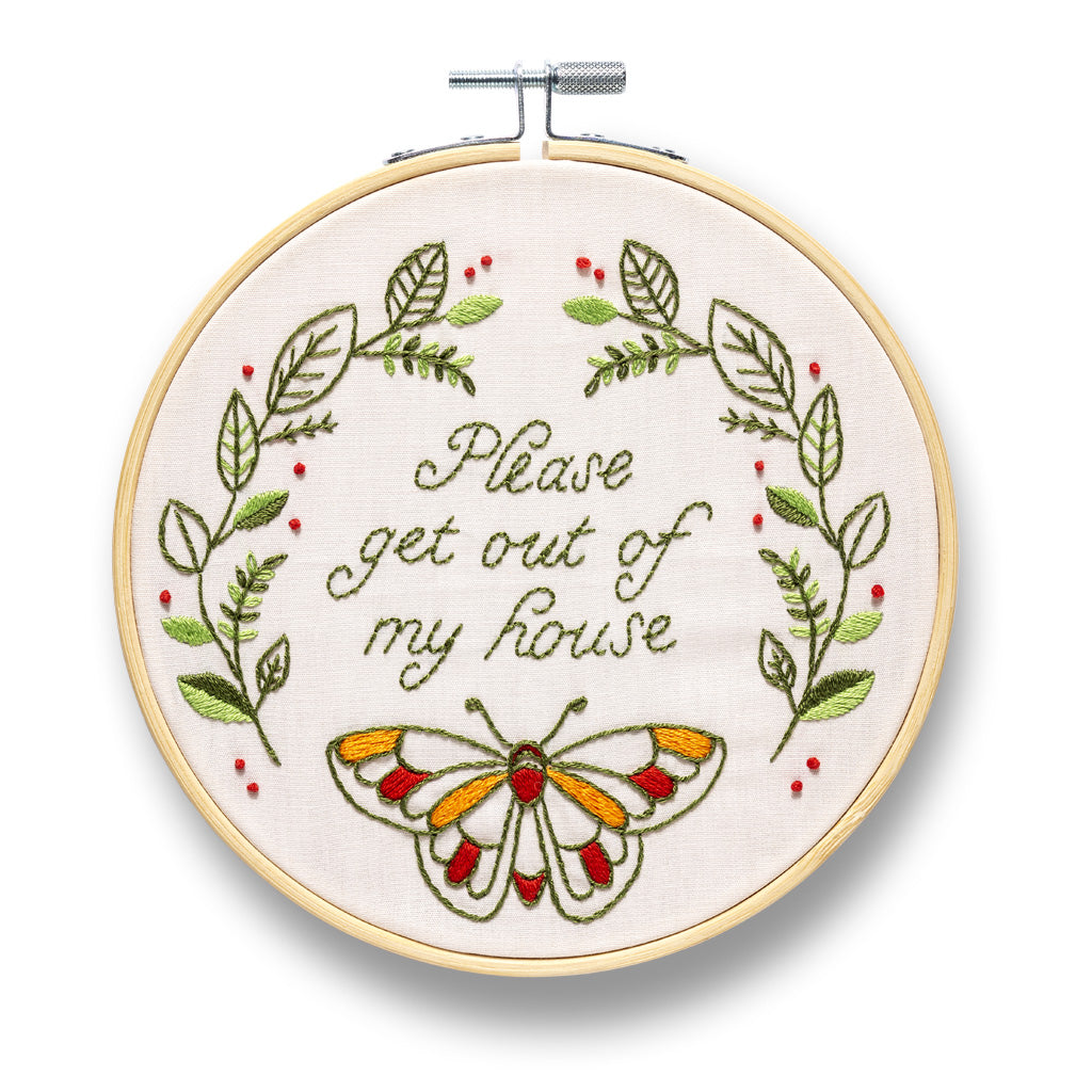 embroidery hoop with completed Please Get Out Of My House design with leafy vine and butterfly design Embroidery