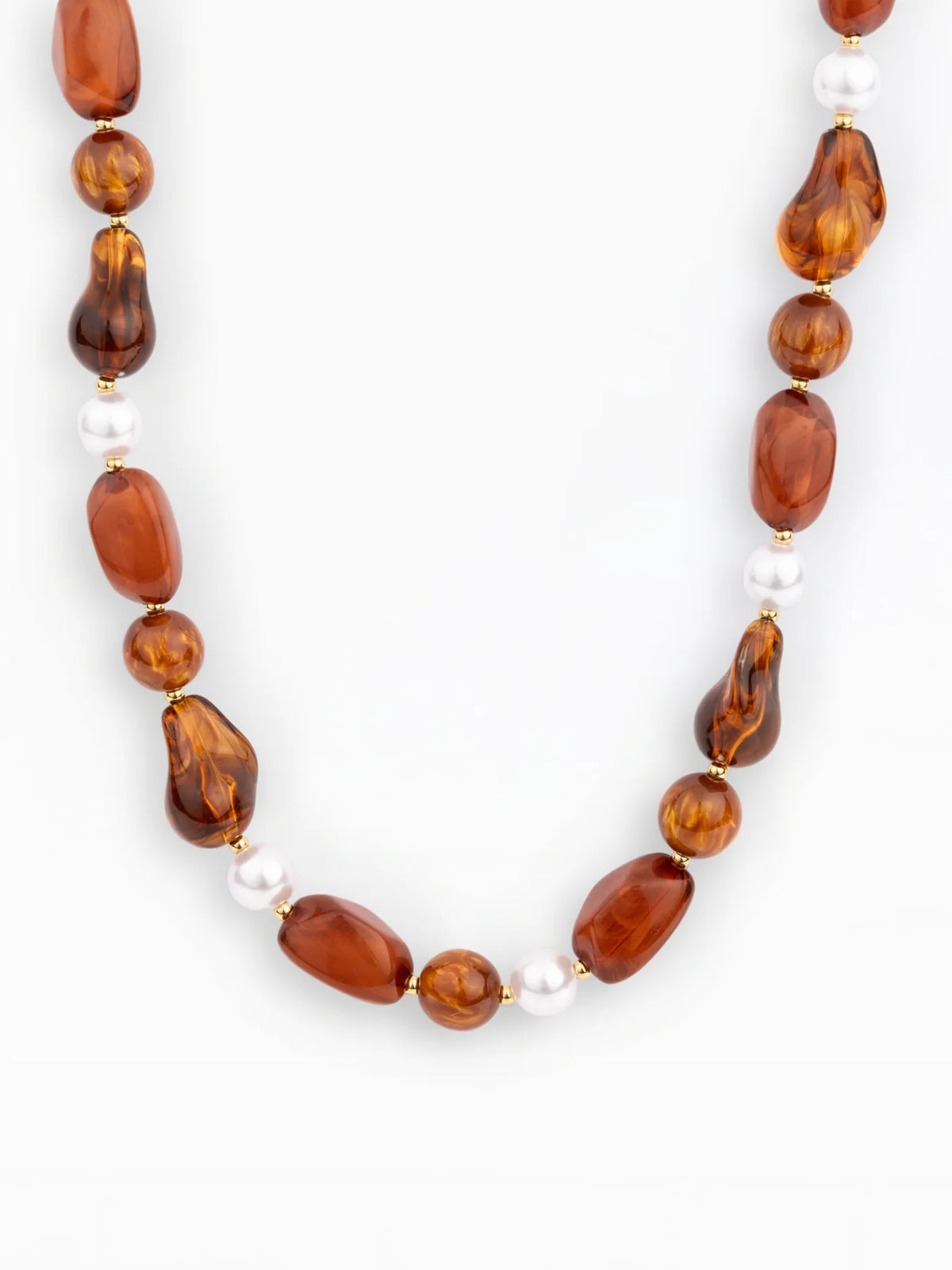 A beaded necklace featuring irregular amber-brown beads and small white pearl-like beads separated by tiny gold spacers, shown on a plain light background.