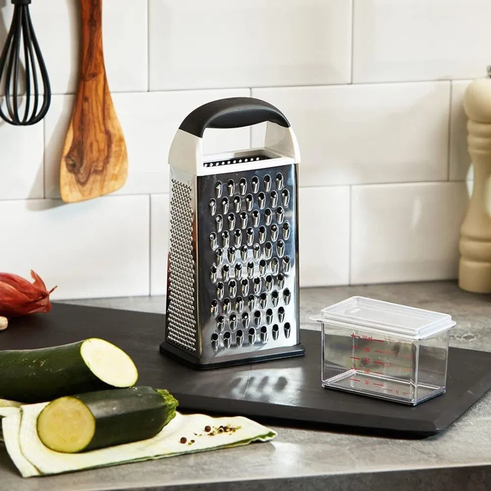 Box Grater set on a countertop with zucchini and kitchen utensils