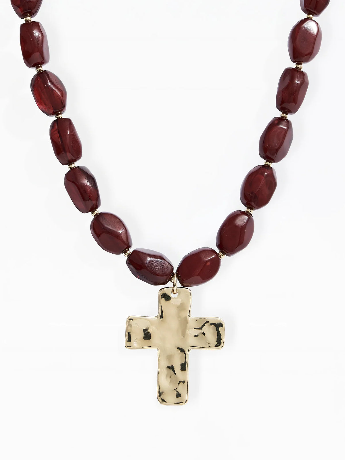 A beaded necklace featuring dark brown faceted beads and a hammered gold cross pendant, displayed against a clean white background.