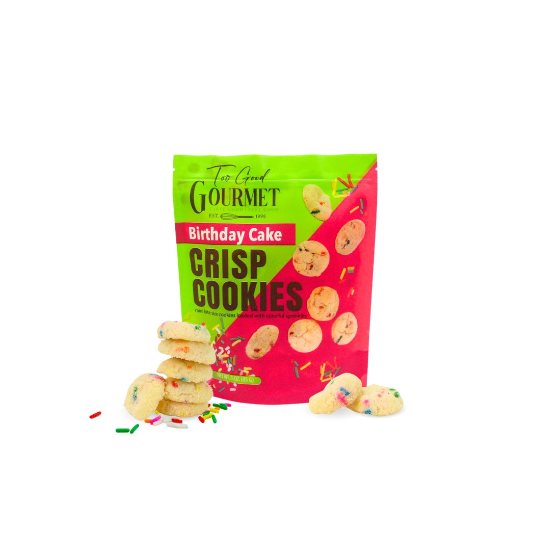 A bag of 'The Good Gourmet' Birthday Cake Crisp Cookies on a white background, with several cookies and sprinkles displayed in front of the packaging.