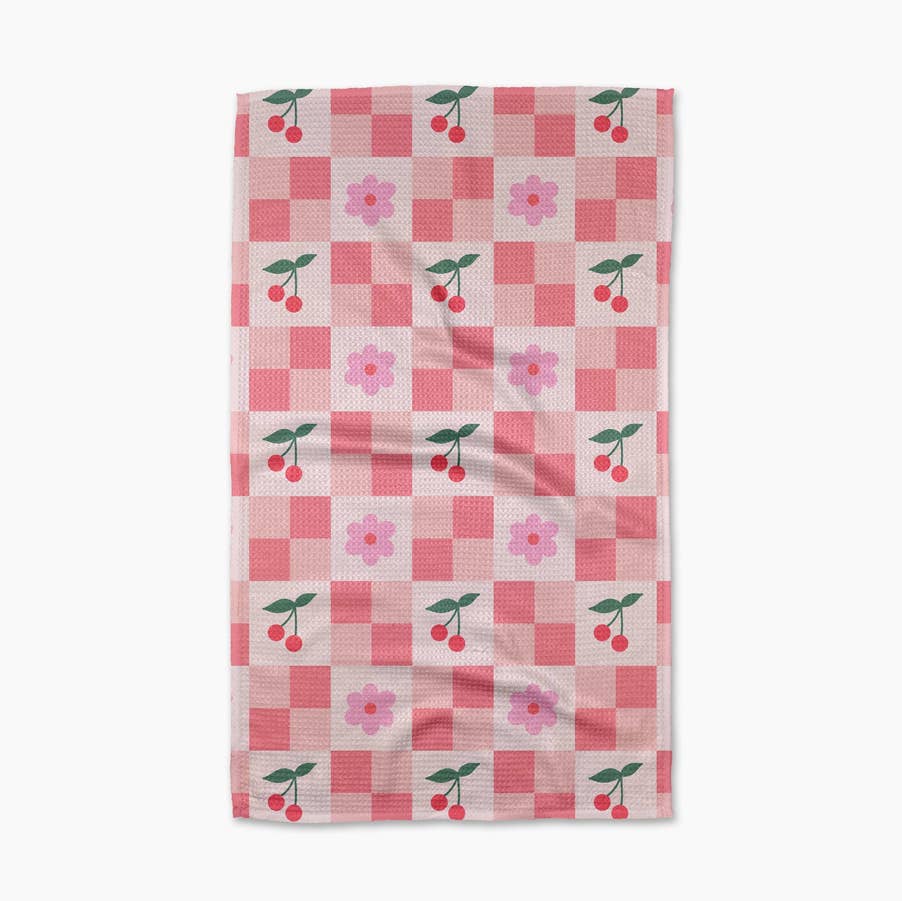 pink checker block print towel with pink flowers and red cherries