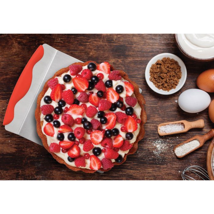 Giant Layer Cake Spatula with fruit filled pastry on it set on a wooden table