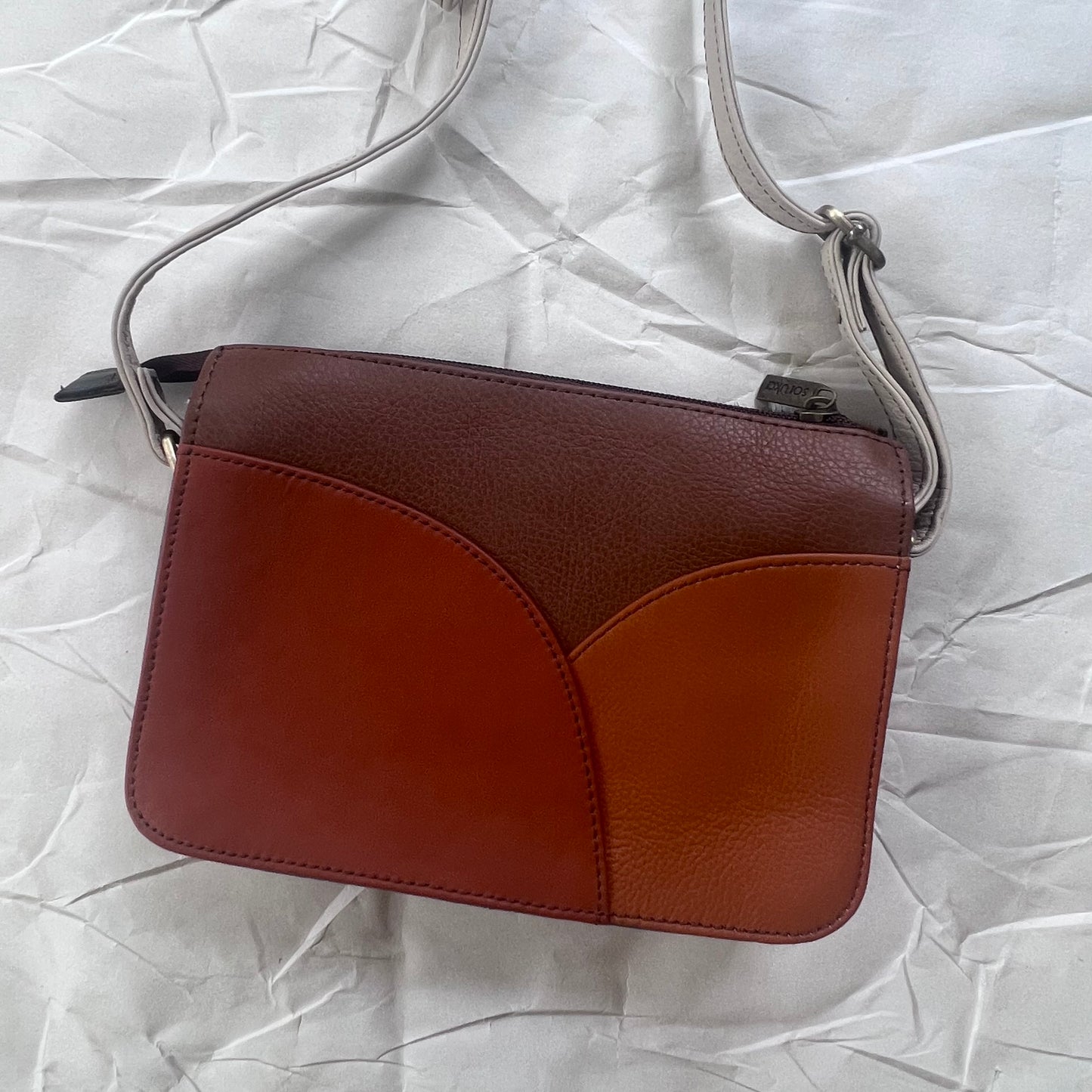 back view of Meredith Purse with orange hues