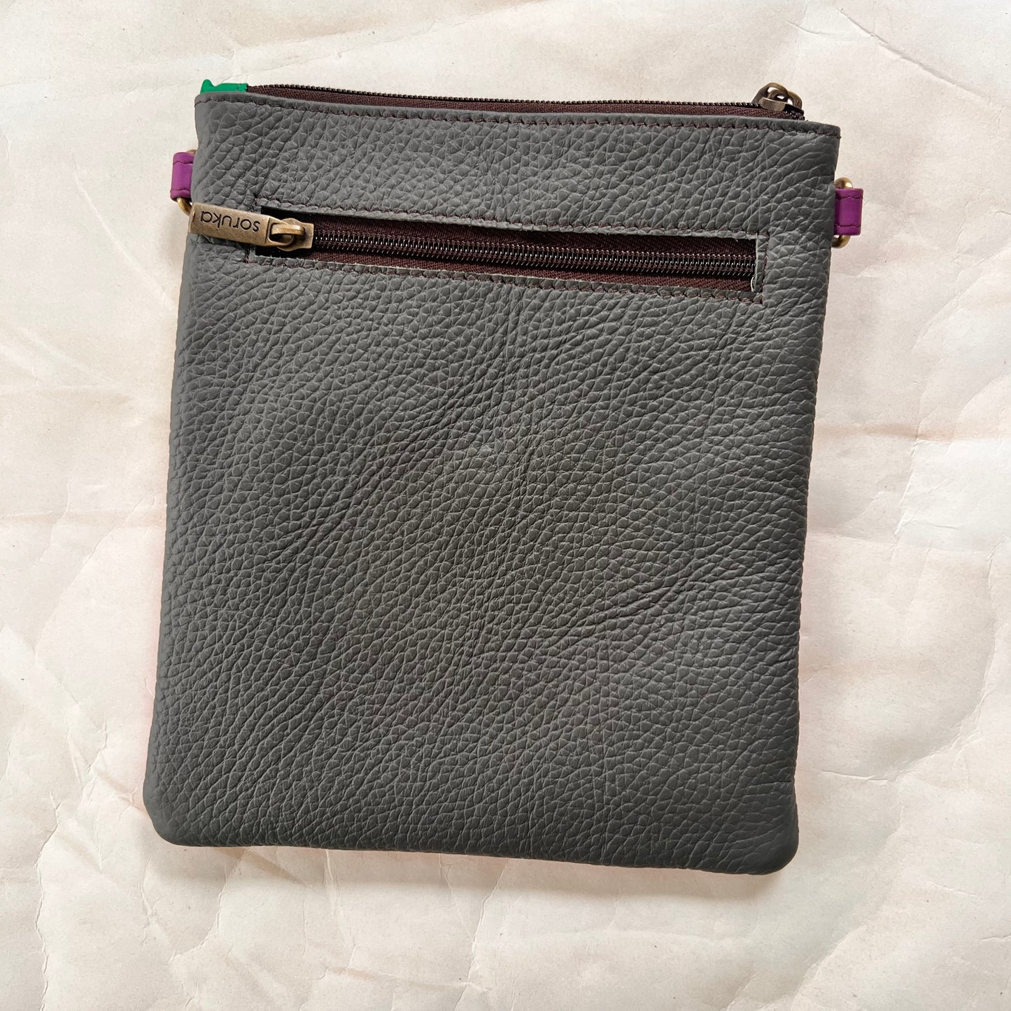 solid grey back of bag.