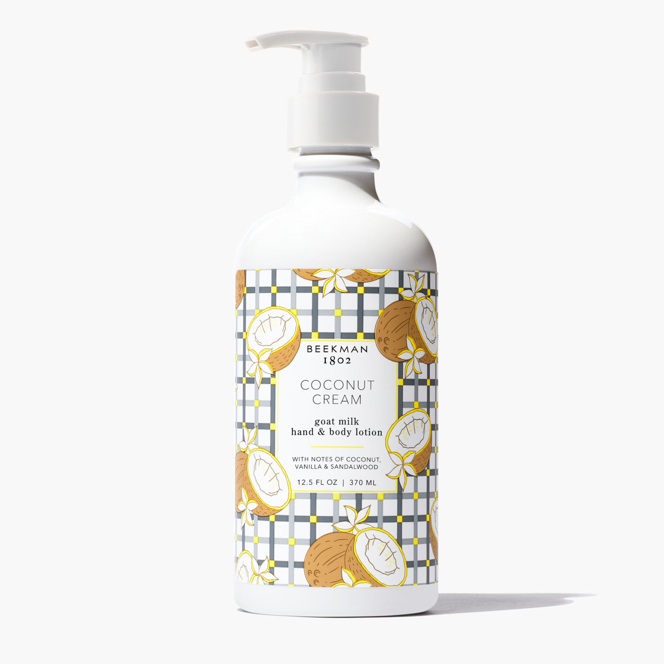 white pump bottle of Coconut Cream Goat Milk Lotion with coconut and grey grid printed boarder